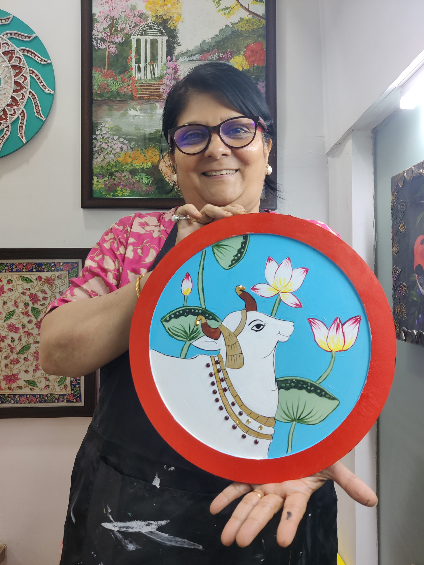 Pichwai-style cow and lotus painting on round canvas